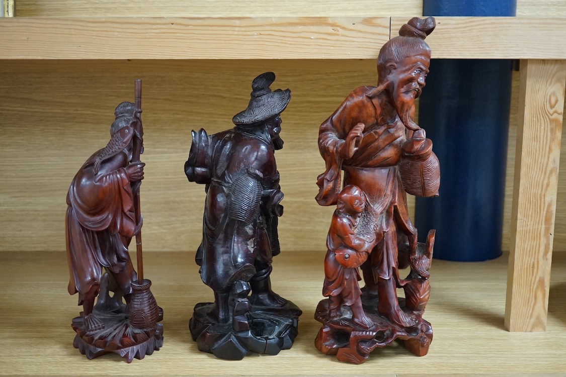 Three Chinese carved wood figures of elders, largest 37cm high